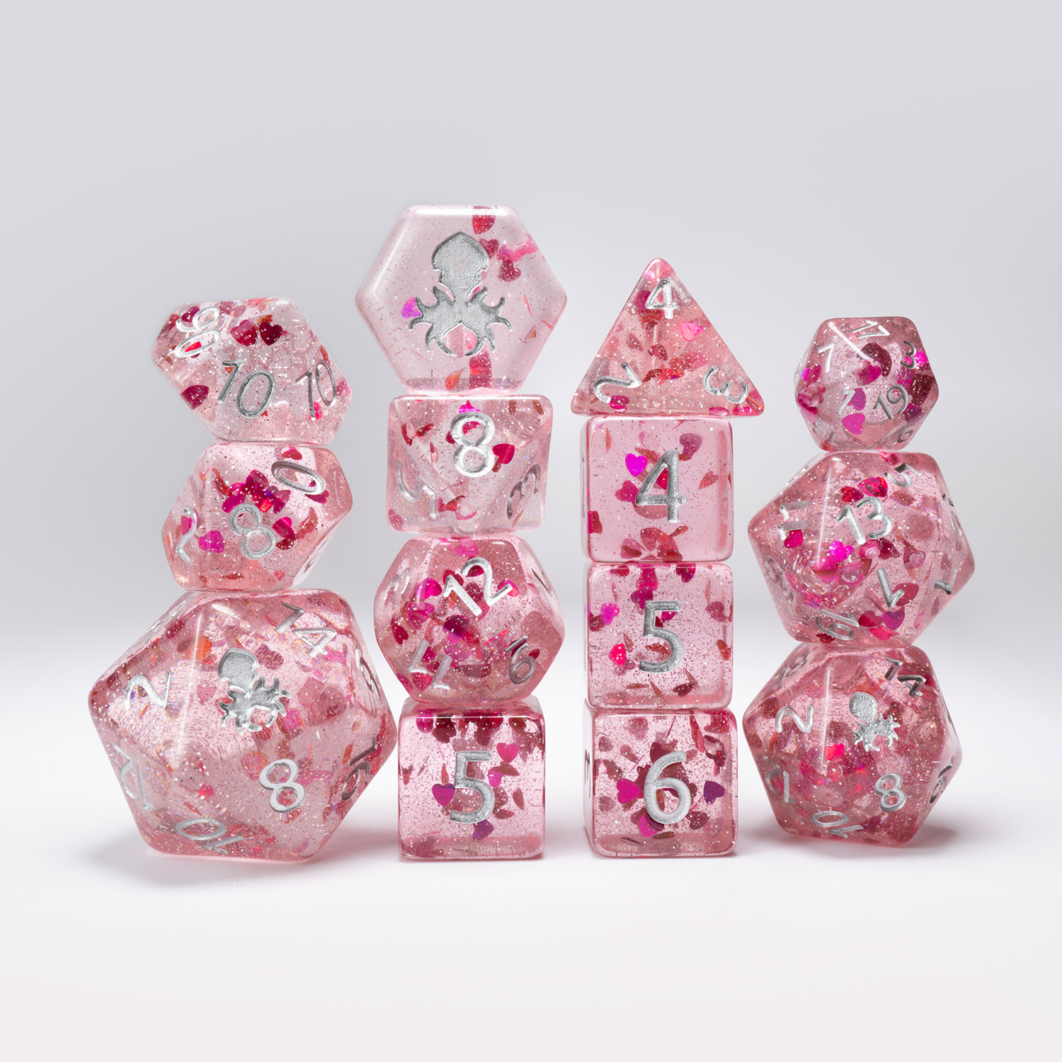 Each Limited Edition Enduring Love dice set features our 14pc Kraken dice set with glitter heart inclusions, a custom Enduring Love dice bag, and matching custom artwork spell card.